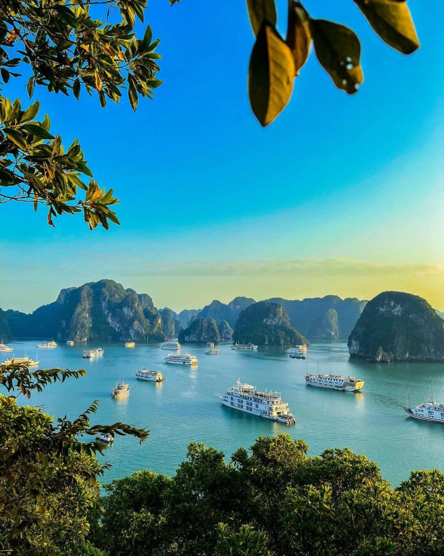 Hạ Long Bay — thousands of limestone karst islands rising from emerald waters at sunrise